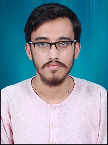 A man wearing glasses and a pink shirt.