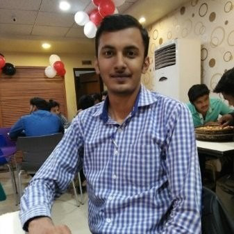 A man sitting at a table in a restaurant.